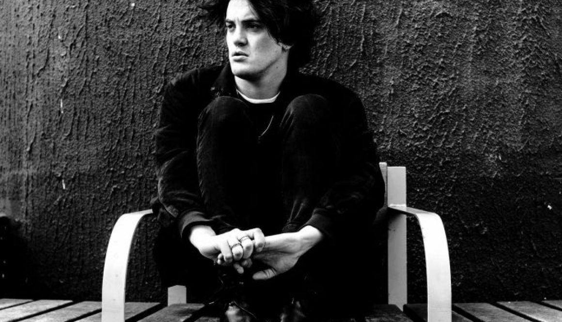 Music artist Freddie Dickson sitting on bench